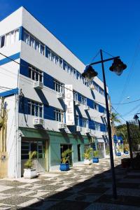 a large building with blue and white at Hotel Praia e Sol in Matinhos