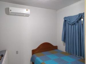 A bed or beds in a room at CASA INTEIRA DOIS QUARTOS COZINHA E SALA