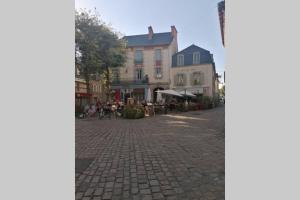 a cobblestone street with a group of buildings at LE TROPICOCO - hyper centre d'Auray - in Auray