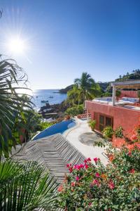 a view of a resort with a pool and the ocean at Casa Azul & Casa Carioca in Careyes in Careyes