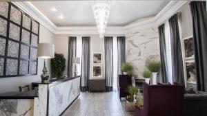 a living room with a chandelier and a lobby at Abbey Inn Cedar City in Cedar City