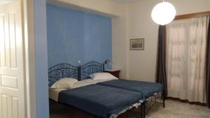 
a bedroom with a bed and a lamp at Vaporia in Ermoupoli

