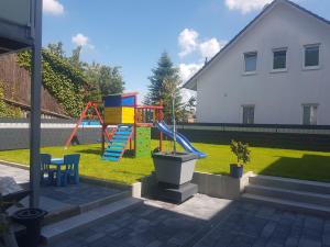 a playground with a slide in a yard at Casa Perla Bianca in Rheinfelden