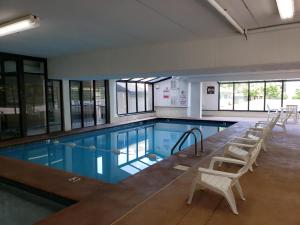 a large swimming pool with chairs around it at Oak Square 201 in Gatlinburg