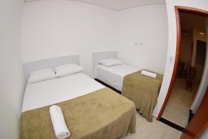 Giường trong phòng chung tại Hotel Numaz