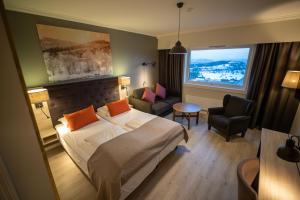 a hotel room with a bed and a chair and a window at Storefjell Resort Hotel in Gol