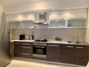a kitchen with brown cabinets and a sink at Apartment Nina in Varaždin
