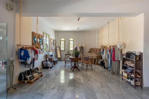 a store with a room filled with lots of clothes at Parosland Hotel in Aliki