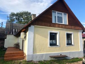 a tiny house with a porch and a deck at Kallaste Hea Karma Villa in Kallaste