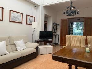 a living room with a couch and a table at Casería San José in Baeza