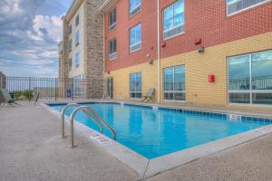 a swimming pool in front of a building at Holiday Inn Express & Suites - Remington, an IHG Hotel in Remington