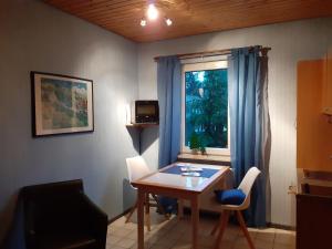 a living room with a table and a window at Villa Tannerhof in Braunlage