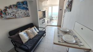 a living room with a couch and a glass table at Best flat beachfront Camogli in Camogli