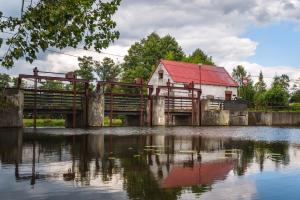 an old bridge over a body of water with a building at Czas na Puszczę in Puszcza Mariańska