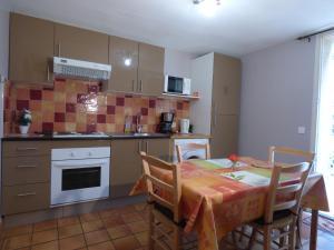 a kitchen with a table and a kitchen with a table and chairs at Gites Croignes-Ponant in Lambesc