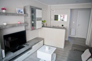 a living room with a flat screen tv on a wall at Zubia Home Portugalete - Impecable- 3 min metro Bilbao in Portugalete