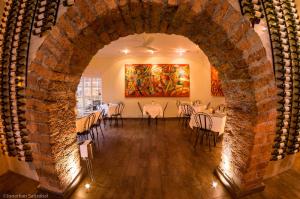 
a dining room with a stone wall and a stone fireplace at 61Prado Hotel in Medellín
