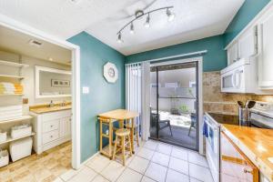 a kitchen with blue walls and a table and chairs at Sand Dollar #5 in Corpus Christi