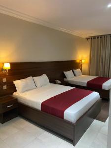 Letto o letti in una camera di Posh Hotel and Suites Victoria Island