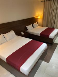 Letto o letti in una camera di Posh Hotel and Suites Victoria Island