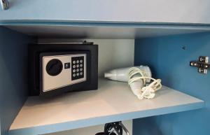 a microwave on a shelf in a room at Komiza Provita Guesthouse in Komiža