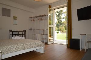 une chambre avec un lit et une porte coulissante en verre dans l'établissement Casa Blanca B&B, à Latina