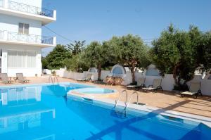 a swimming pool in front of a hotel at Astir Hotel in Karlovasi