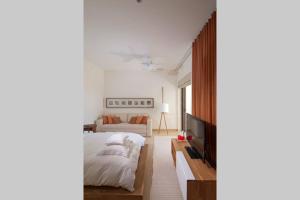 a white bedroom with a bed and a couch at Spectacular Beachfront at veneros fully staffed in Cruz de Huanacaxtle +40 photos