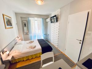 a small room with a bed and a door at Komiza Provita Guesthouse in Komiža