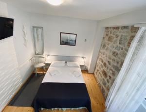 a small bedroom with a bed in a room at Komiza Provita Guesthouse in Komiža