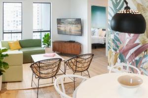 a living room with chairs and a table and a couch at The Laundry Rooms - Waterloo in Waterloo