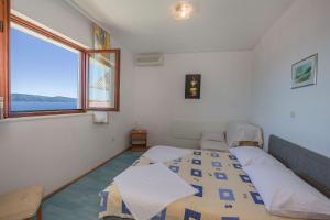 Posteľ alebo postele v izbe v ubytovaní Apartments Dragana