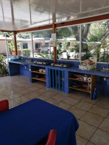 a kitchen with blue counters and a blue table at Puerto Vargas lodge in Cahuita