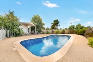 a large swimming pool in a yard at Kennedy Holiday Villas in Mulwala