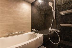 a bathroom with a bath tub and a shower at Tokyo Bay Shiomi Prince Hotel in Tokyo