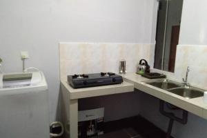a small kitchen with a sink and a stove at Meru Homestay suitable for up to 7 people in Klang