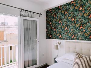 
a bedroom with a white bed and a window at Boutike Guesthouse in Seville

