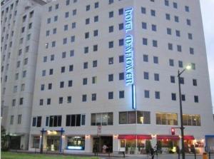 a large white building with a sign on it at Hotel Mayflower Sendai in Sendai