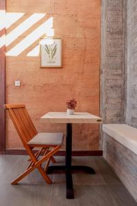 a table and a chair next to a wall at Seven Havens Residence in Selong Belanak
