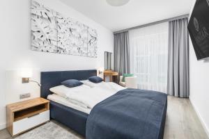 Nadmorskie Tarasy SPA 2 by Jantar Apartamenty Kołobrzeg房間的床 +81 張相片