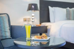 A bed or beds in a room at Amaryllis Hotel Blantyre
