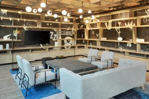 a dining room with a table and chairs and a tv at Ibis Samarinda in Samarinda