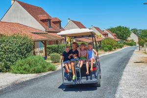 a group of children sitting on a trolley at Domaine de Lanzac in Lanzac