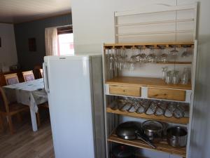 a kitchen with a refrigerator and a dining room with a table at Holiday Home Ivalo in Ivalo