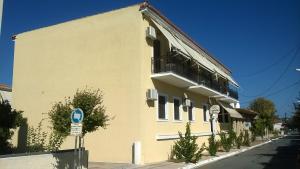 a yellow building with a balcony on a street at Castello Methoni in Methoni +54 photos