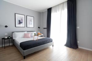 a bedroom with a bed with a table and a window at Il Pumo - Apulian Rooms Bari Piazza Moro in Bari