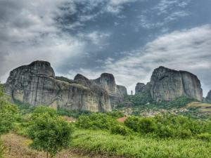 a group of large rock formations on a hill at Hotel Doupiani House in Kalabaka