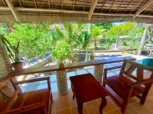a room with a table and chairs and a view of the garden at Moalboal T Breeze Coastal Resort in Moalboal