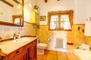 a bathroom with a sink and a toilet and a mirror at Son Poca Palla in Sant Llorenç des Cardassar +25 photos