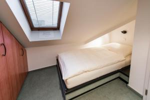a bed in a room with a window at Haus Elbstrom, Whg. 26 in Cuxhaven